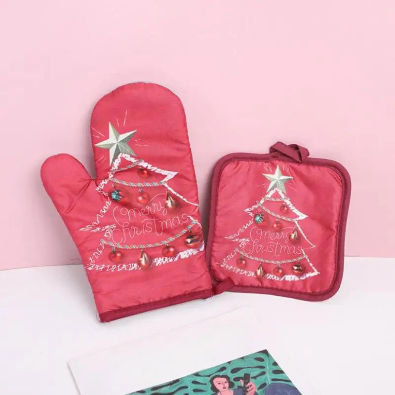 A pair of festive red insulated oven mitts featuring a Christmas tree design with glitter and festive text