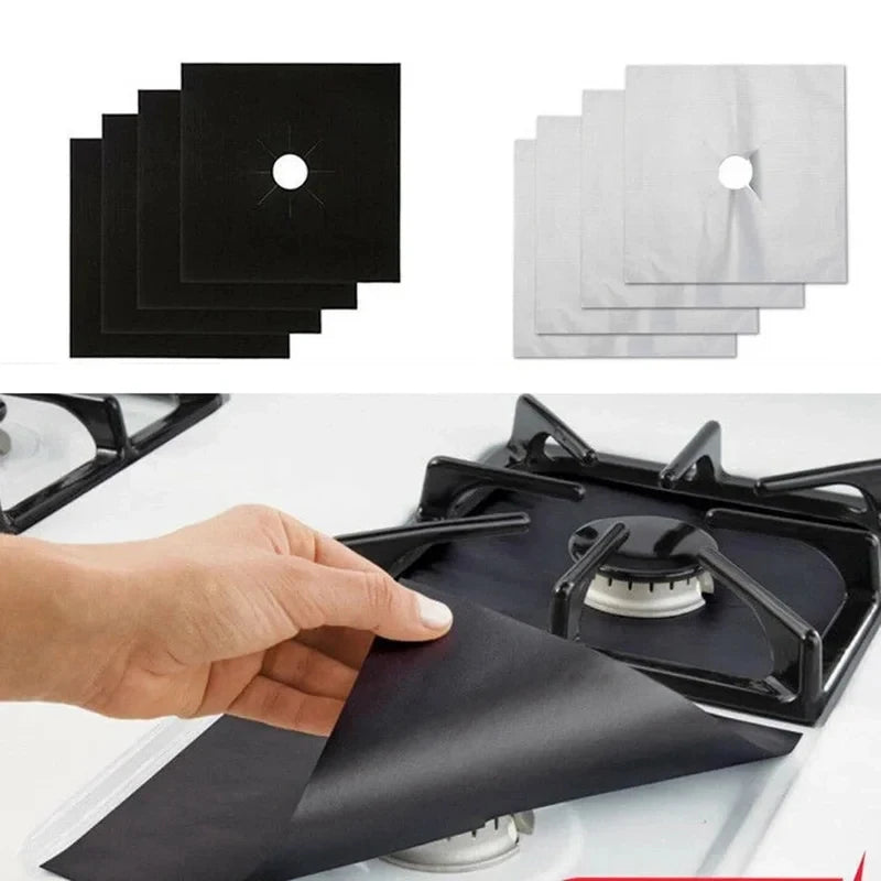 A hand places a black reusable aluminum stove burner protector mat onto a stovetop.