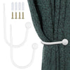 A set of white retro metal curtain holdback hooks and corresponding screws shown next to a dark teal curtain.