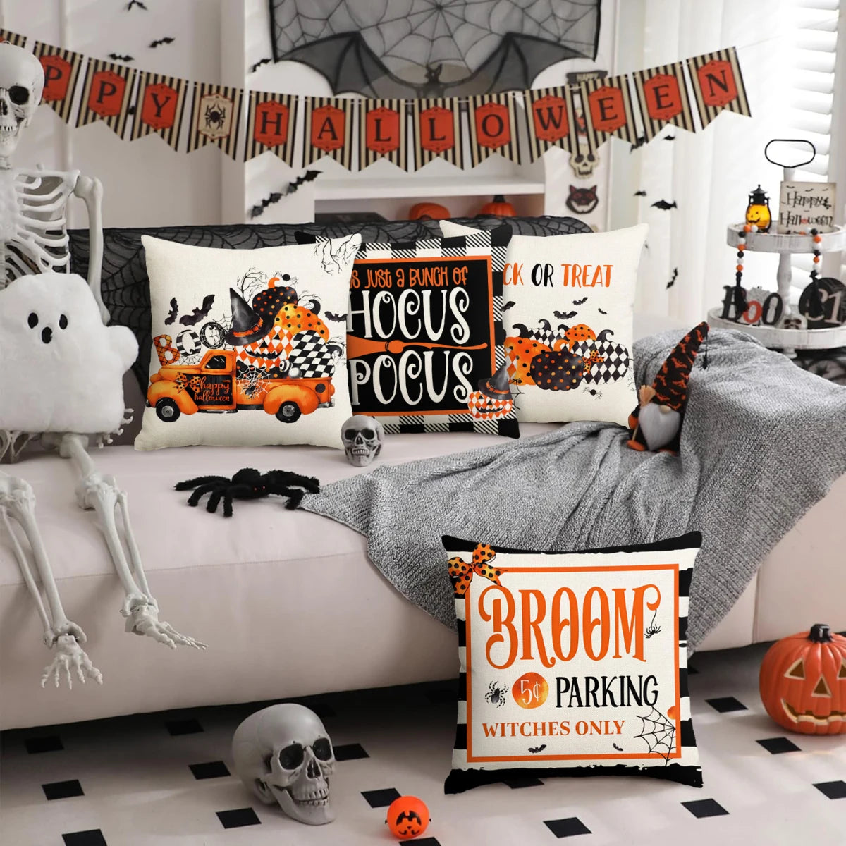 A set of four Halloween cushion covers featuring ghost, pumpkin, and skull designs displayed on a sofa.
