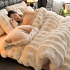 A woman relaxing on a fluffy beige plush rabbit hair bedding set on a bed.