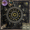 A dark fabric featuring an astrological tarot card layout with celestial symbols and gold accents.