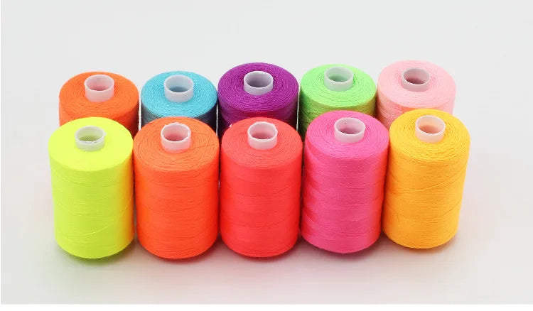 A row of ten colorful polyester sewing thread spools in various shades including orange, pink, green, and yellow.