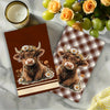 Two brown calf illustrations on plaid kitchen towels with floral accents.