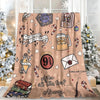 A beige flannel throw blanket featuring various illustrations and text on a light background.