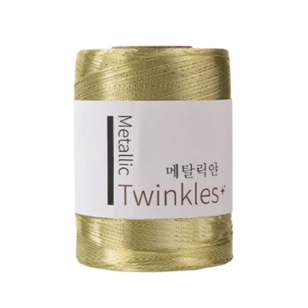 A spool of metallic gold Twinkles yarn for crafting.