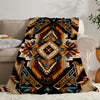 A soft flannel throw blanket featuring an ethnic print with geometric patterns in earth tones and blues.