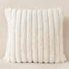 A row of white stripe corduroy pillow covers standing upright against a light background.