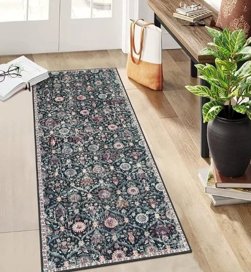 A dark floral vintage trellis rug runner placed on a light wood floor next to a wooden table.
