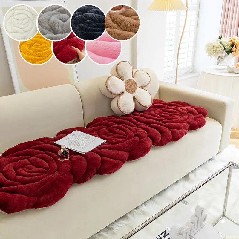 A beige sofa decorated with a deep red, rosette-patterned mat and several circular fabric swatches.