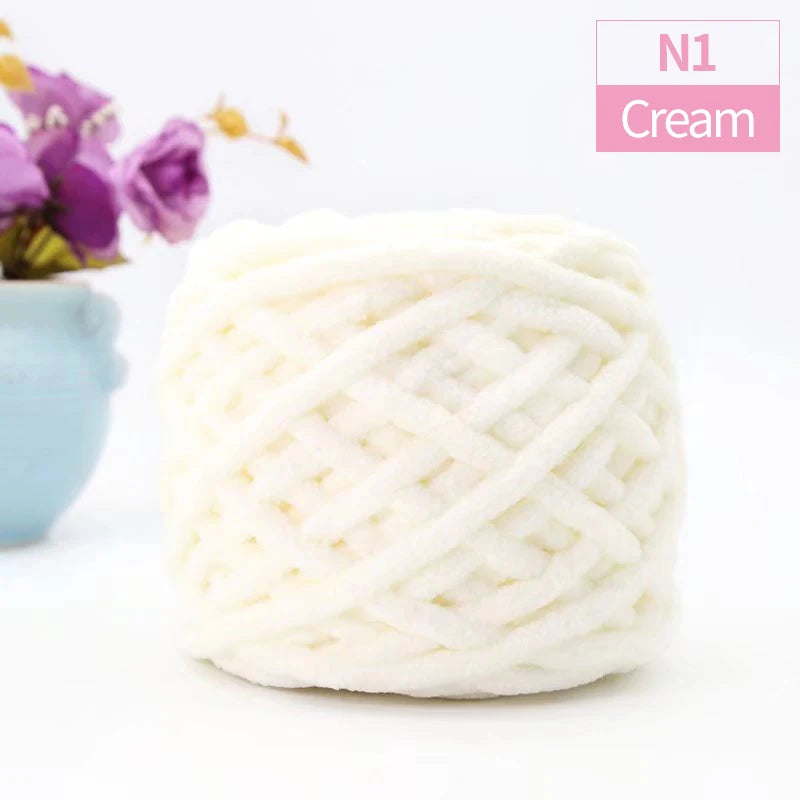 A ball of white cream colored chunky velvet knitting yarn labeled N1 Cream.
