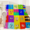 A colorful set of cartoon-themed throw blankets displayed on a sofa.