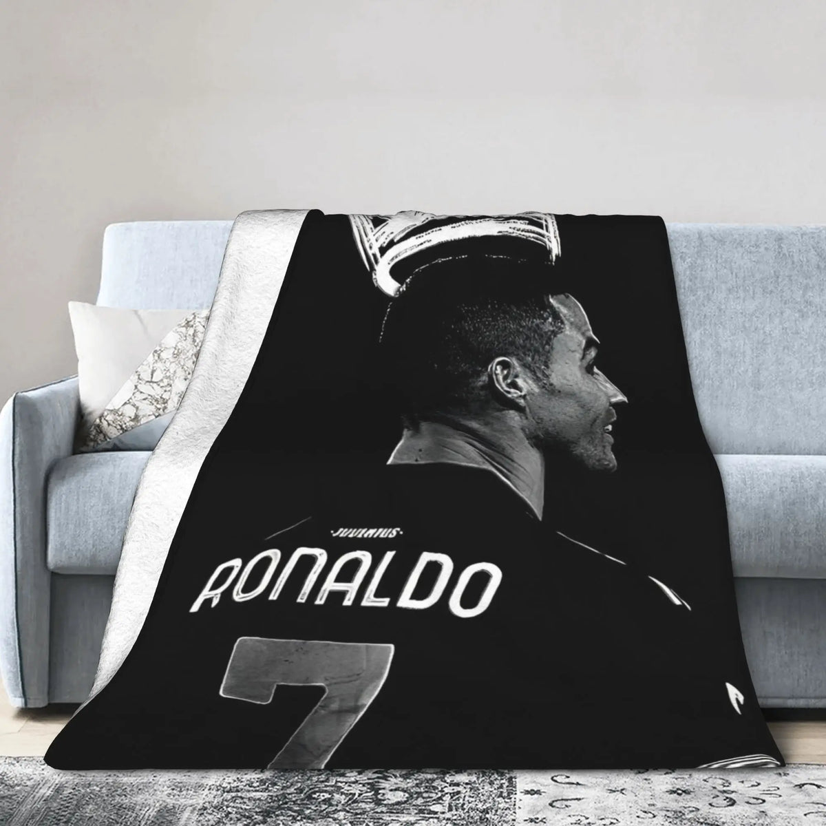 A black and white graphic featuring a profile of Ronaldo wearing a soccer jersey on a wool throw blanket.