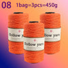 Three spools of orange hollow yarn for knitting and crochet, totaling 450g.