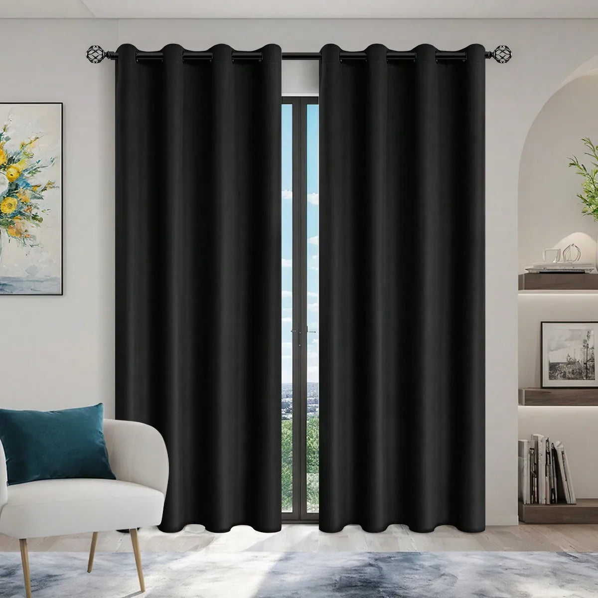 Solid black blackout privacy curtains with grommets hanging in a doorway.