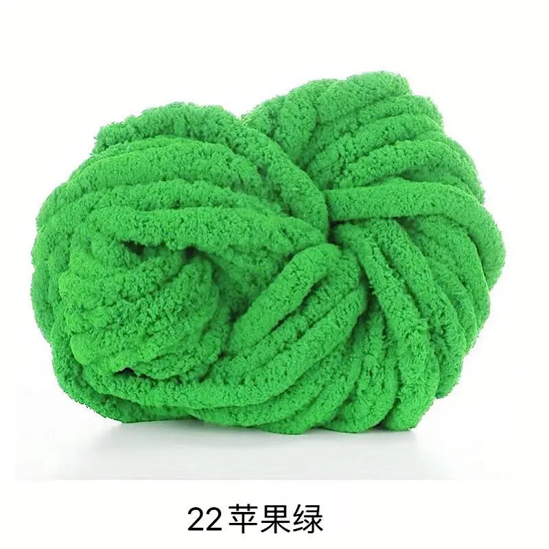 A ball of bright green chunky acrylic yarn for knitting and crochet projects.
