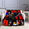 A black and orange printed flannel travel blanket featuring KISS band artwork.