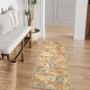 A long vintage trellis rug runner with floral patterns lies on a light wood floor.
