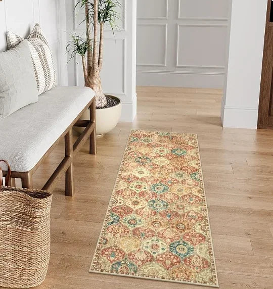 A long vintage trellis rug runner with floral patterns lies on a light wood floor.