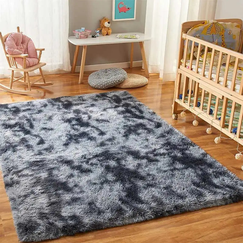 A dark gray and black fluffy shag rug placed on a wooden floor in a bright room.