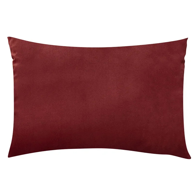 A solid maroon velvet throw pillow cover.