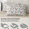 A close-up of a beige pillowcase with a white heart print, showing the envelope closure design.