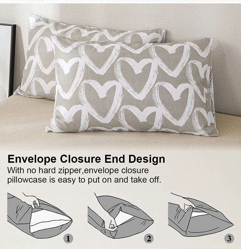 A close-up of a beige pillowcase with a white heart print, showing the envelope closure design.