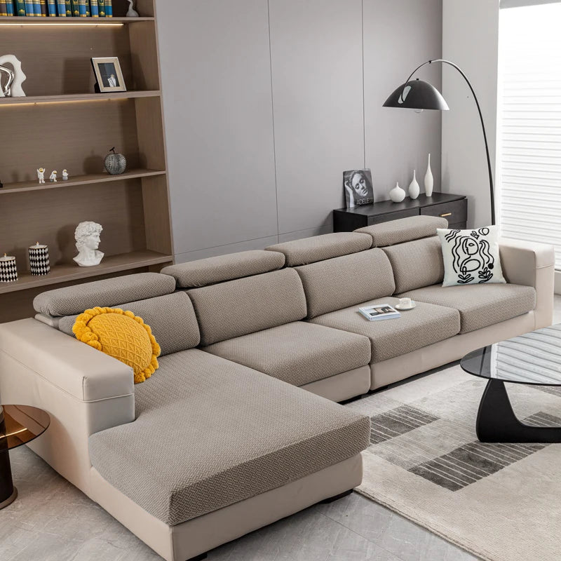 A light beige Jacquard knit sofa cushion cover on a modern sectional sofa with a yellow accent cushion.