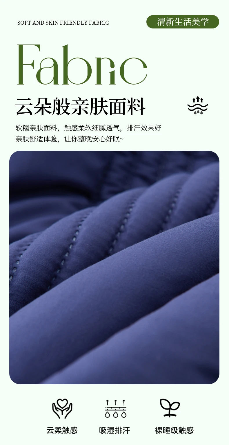 Close-up of a dark blue quilted fabric texture showing soft folds and stitching.