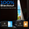 A dark room interior showing a window with 100% blackout curtains blocking bright daylight.