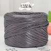 A spool of metallic gray cake yarn with 12 strands coiled for crafting.