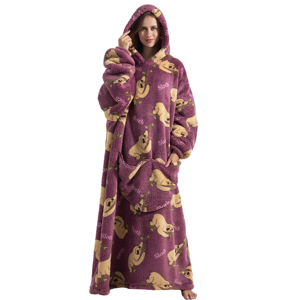 A woman wearing a purple sherpa fleece oversized blanket hoodie with a hood and front pocket.