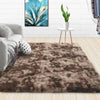 A luxurious brown velvet anti-slip floor mat placed on a light wooden floor with a white plant stand in the background.