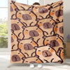 A tan flannel blanket featuring a repeating pattern of cute brown bear faces with simple outlines.