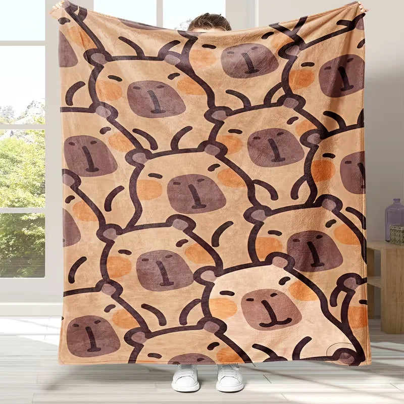 A tan flannel blanket featuring a repeating pattern of cute brown bear faces with simple outlines.