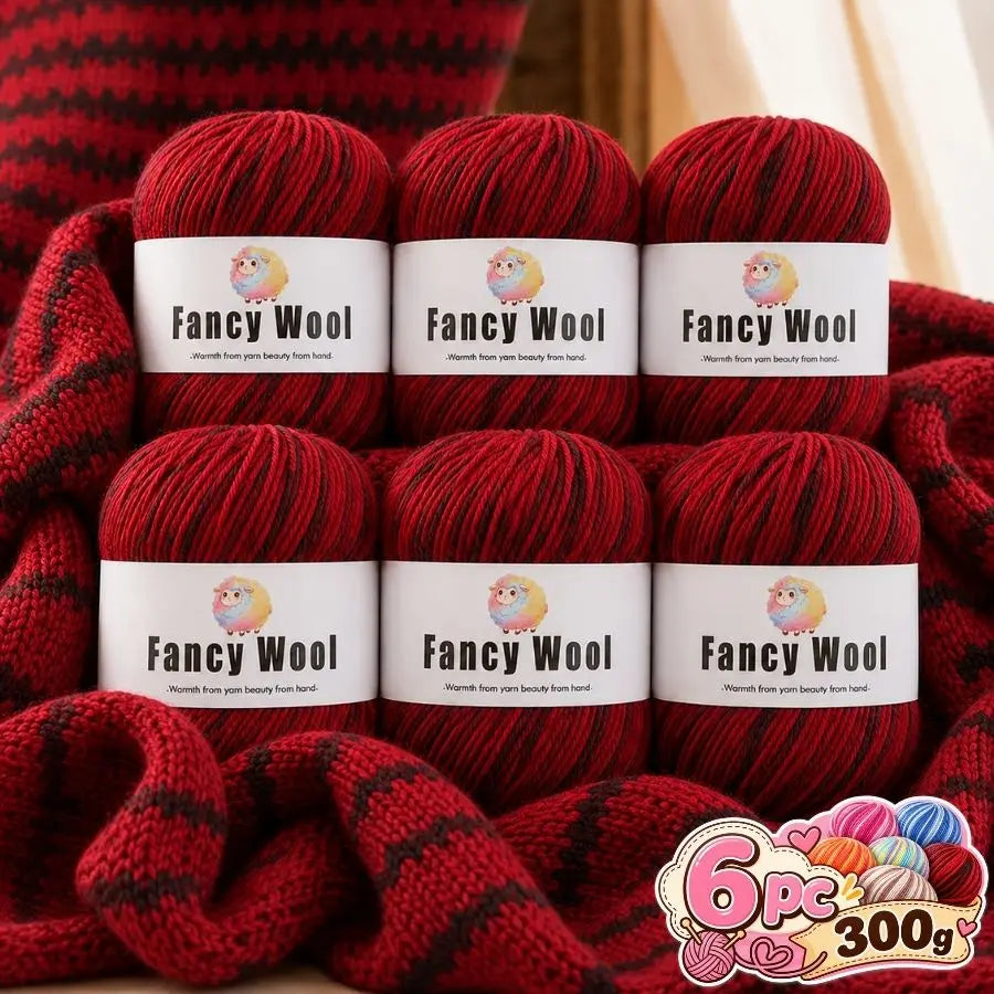 Three skeins of red wool yarn labeled Fancy Wool are displayed on a fabric background.