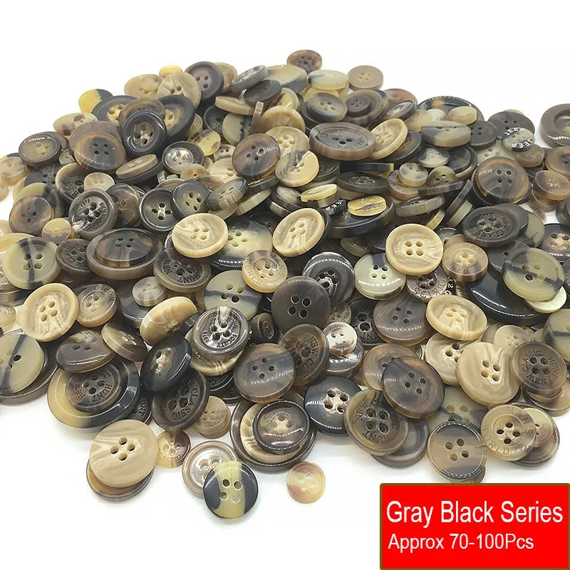 A pile of assorted gray and black resin sewing buttons for crafting and DIY projects
