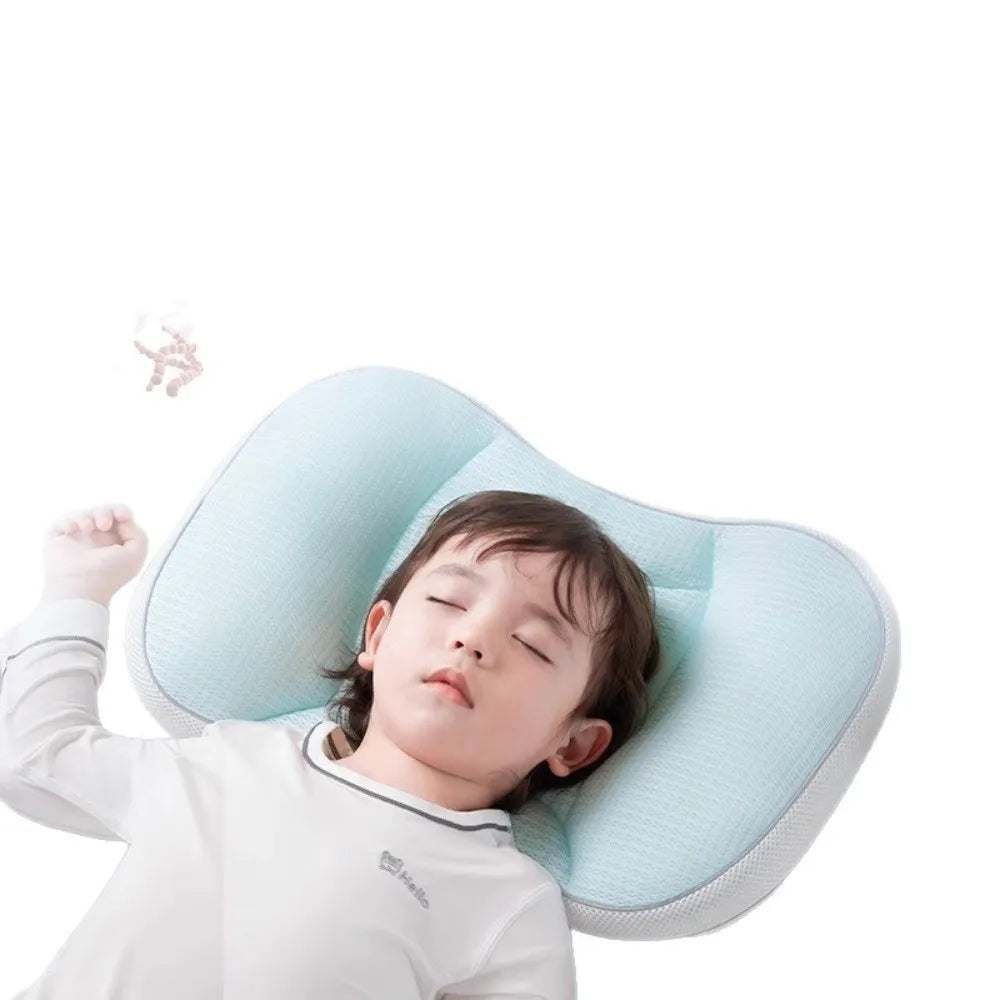 A baby is lying on a light blue breathable sleep pillow.