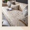 A beige luxury chenille sofa cover featuring a geometric gold pattern on a sectional sofa.