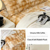 A fluffy, golden-brown rabbit plush long pillowcase displayed on a bed with a white knitted blanket and a mug.