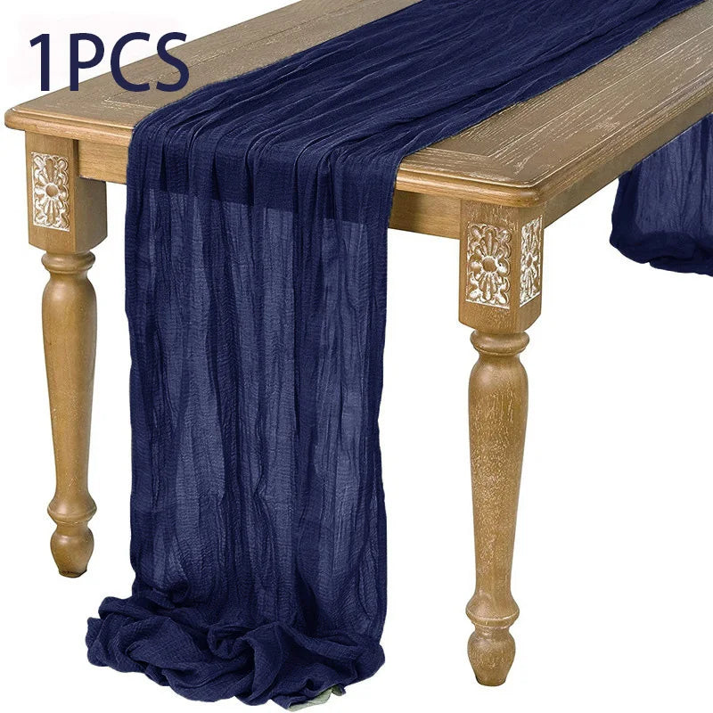 A dark blue semi-sheer gauze fabric draped over a wooden table.