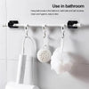 White hanging rod with brackets displaying bath towels, balls, and brushes in a bathroom setting