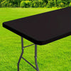 A black waterproof rectangle tablecloth is shown on a folding table outdoors on green grass.