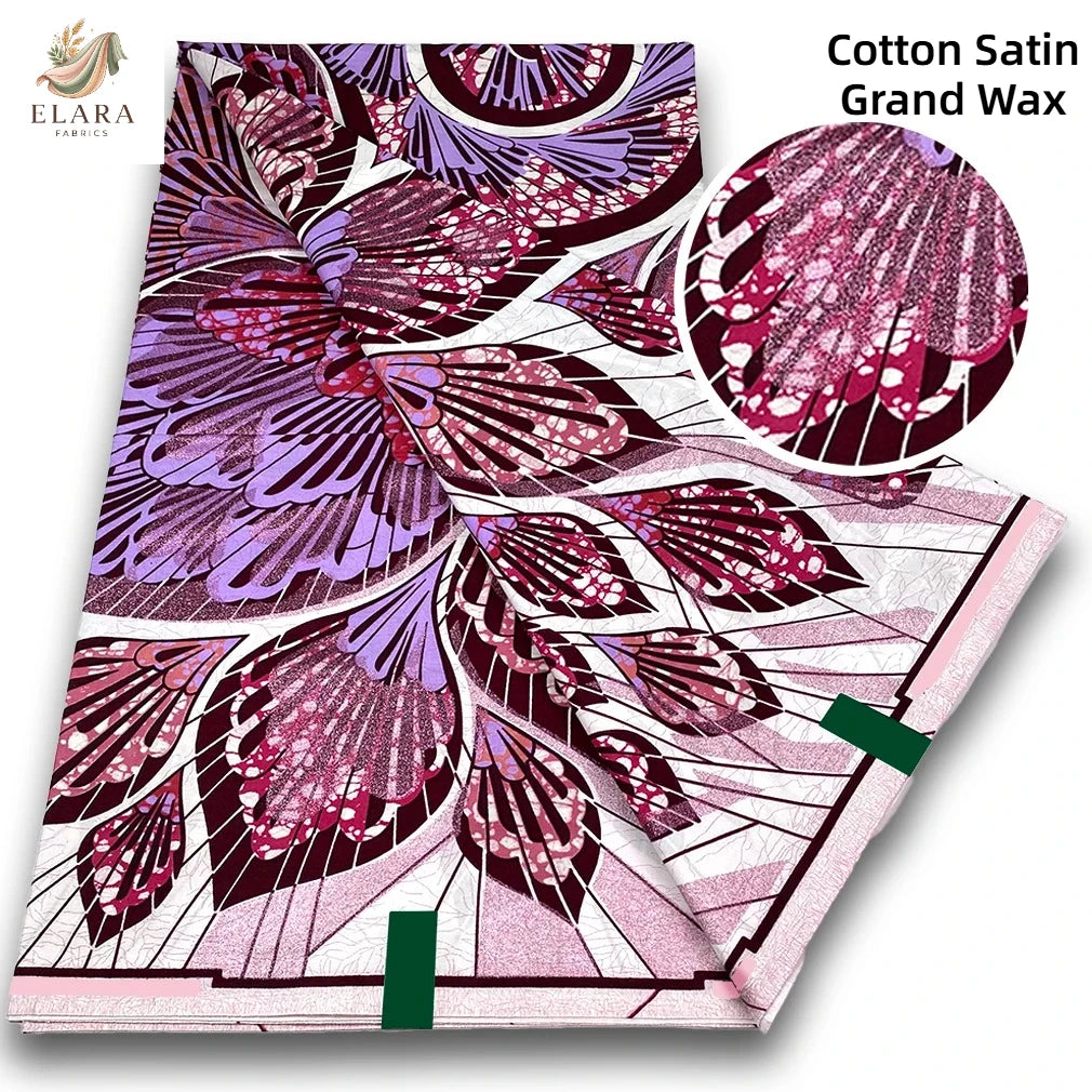 A folded piece of Cotton Satin Grand Wax fabric featuring a vibrant purple and pink floral pattern.