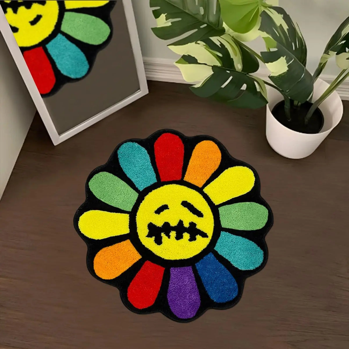 A colorful, embroidered sunflower design on a black mat, featuring various bright colors like yellow, orange, green, and purp