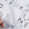 Close-up of water-soluble adhesive embroidery stabilizer sheets with various line drawings of leaves and floral elements.