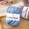 A ball of blue and white gradient alpaca wool yarn labeled Fancy Wool with a 6 piece set.