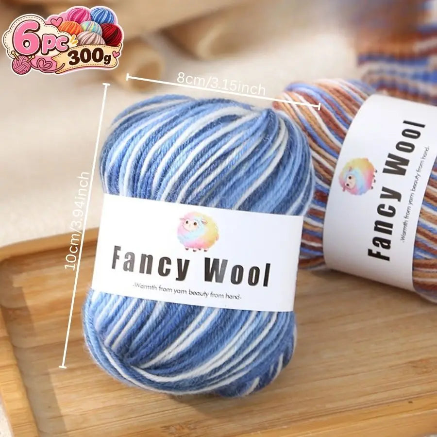 A ball of blue and white gradient alpaca wool yarn labeled Fancy Wool with a 6 piece set.