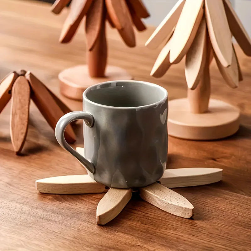 A ceramic mug rests on a wooden placemat, surrounded by wooden tree-shaped coasters.