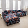 A stylish printed sofa protector cover in shades of blue, brown, and black is displayed on a light floor.